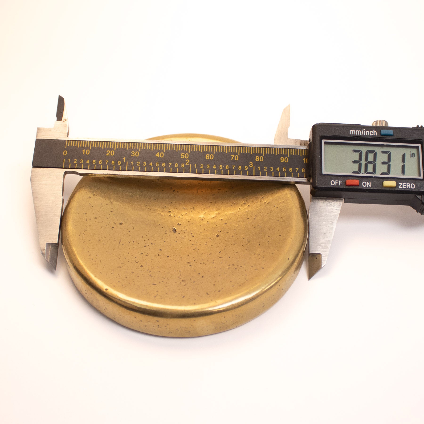 Bronze bowl casting being measured by calipers 3.831 inches