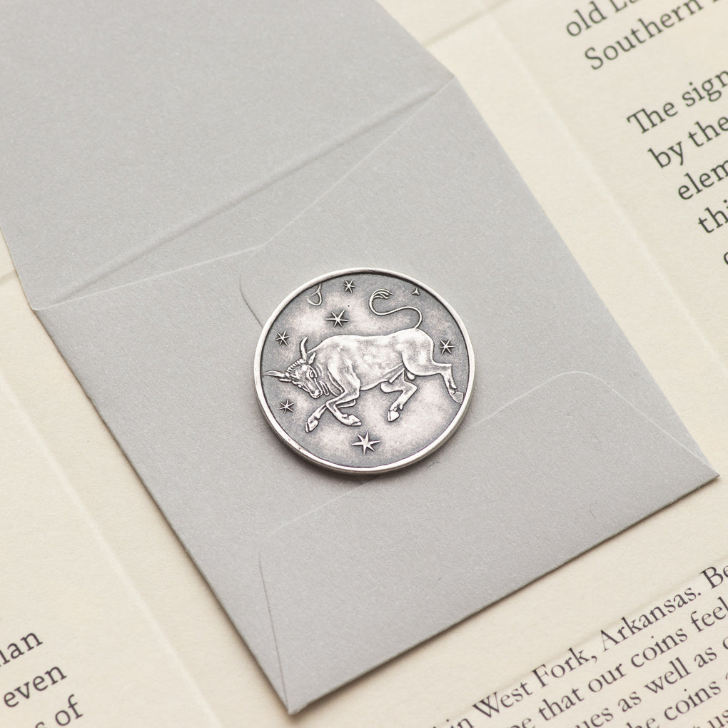 Shire Post Mint Silver Zodiac Taurus Moon Coin packaged inside paper foldy