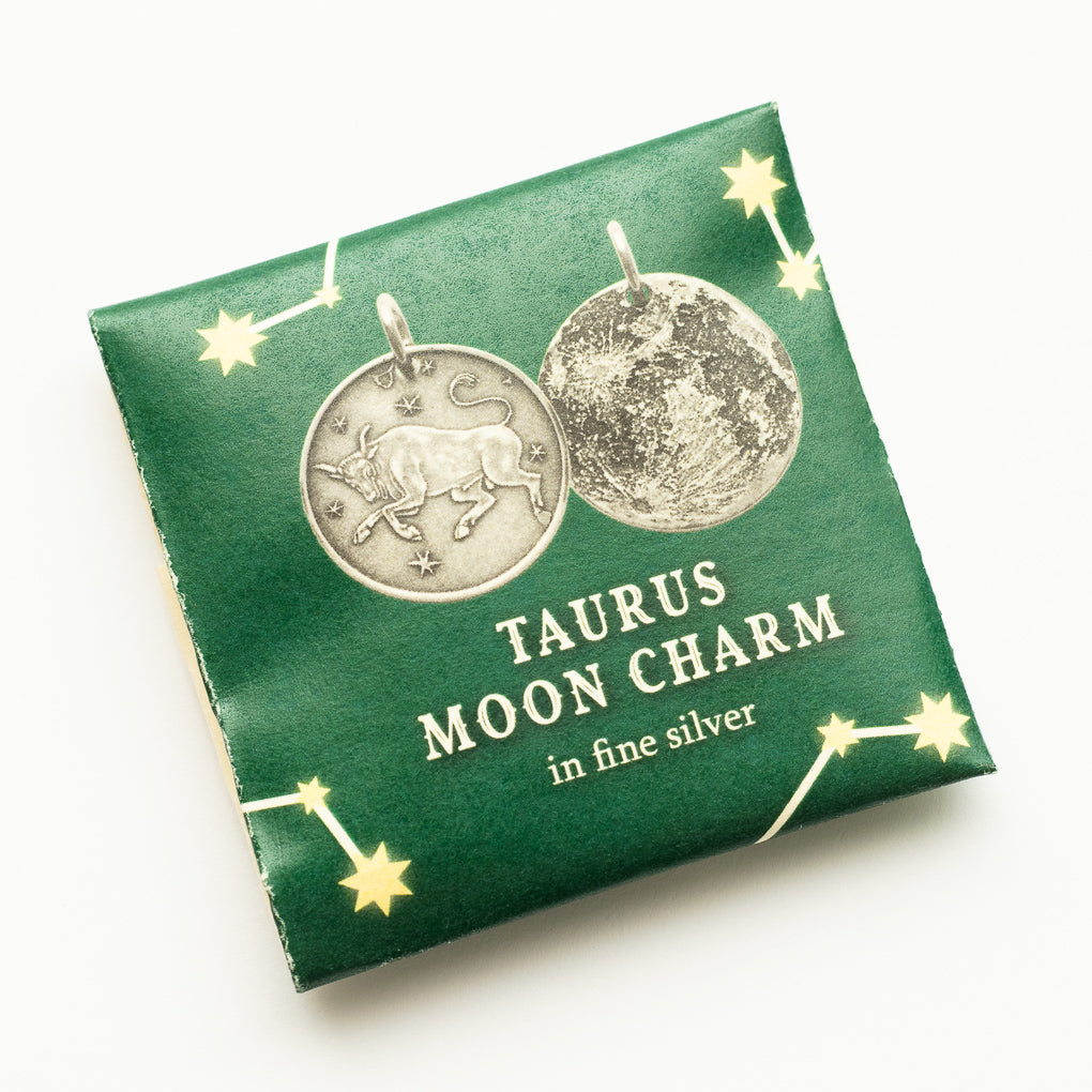 Shire Post Mint two-sided Silver Zodiac Taurus Moon Charm packaged in paper foldy