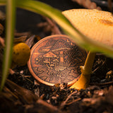 Fungus Fungible Copper Decision Maker Token Coin by Shire Post Mint, coin resting beside a mushroom stalk, depicting a mycelium network underground..
