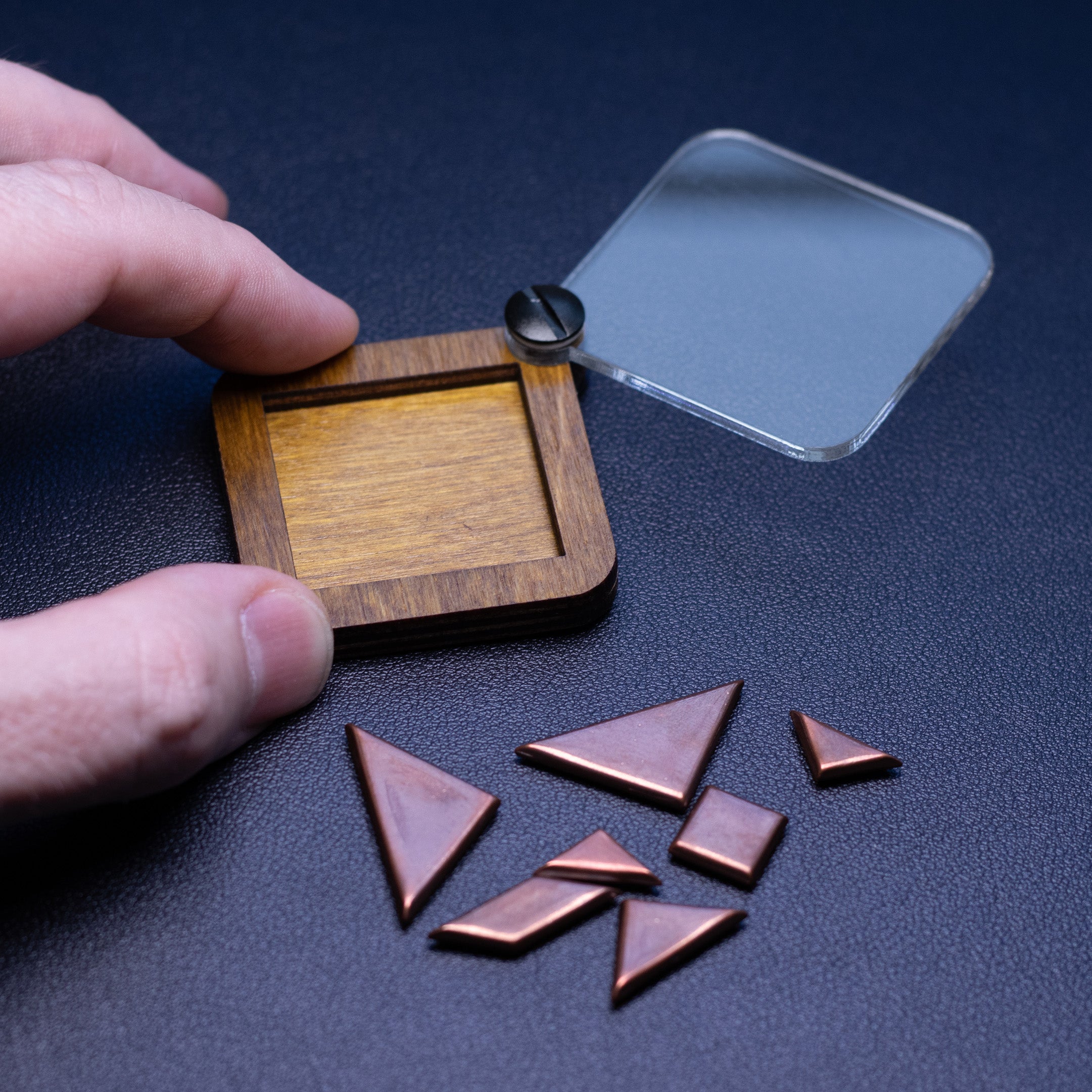 Open box next to Tangram Puzzle pieces 