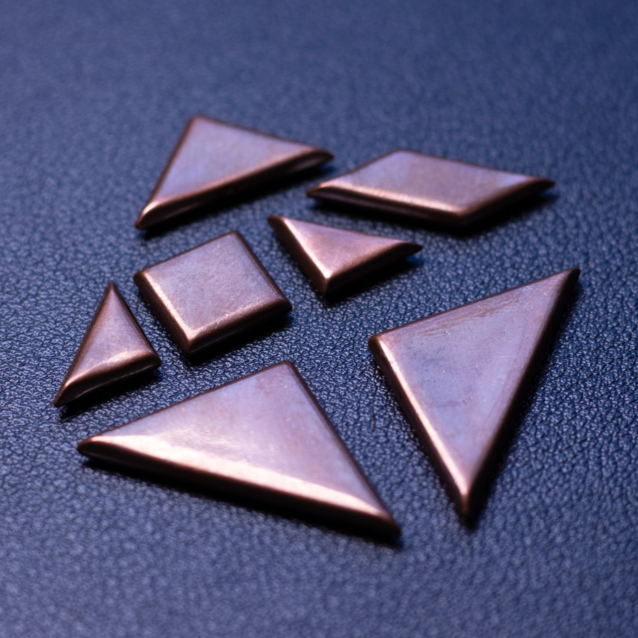 Broken solid copper tangram puzzle