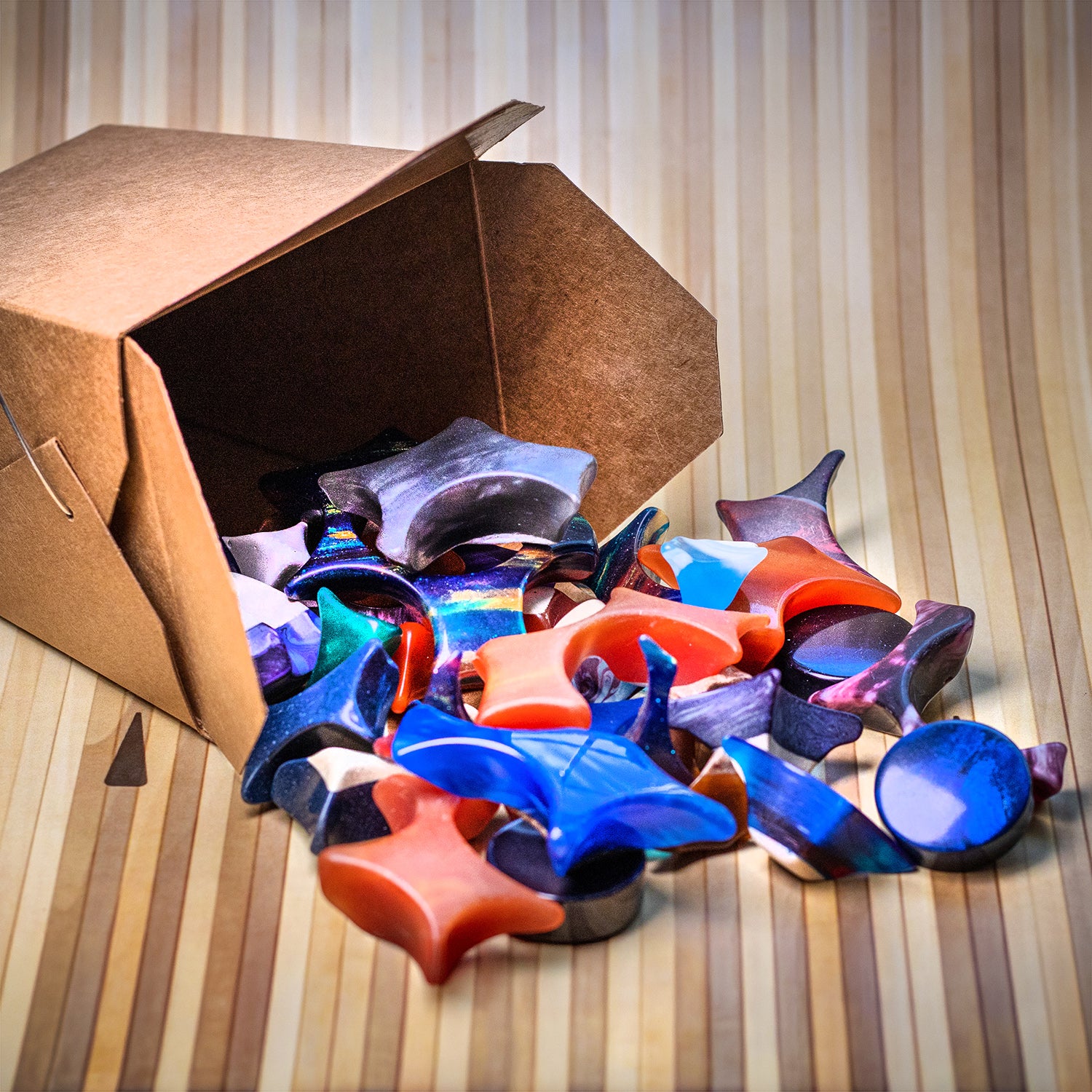 Takeout container spilling out colorful Shire Post Mint Bowlerite Fidget Chunks