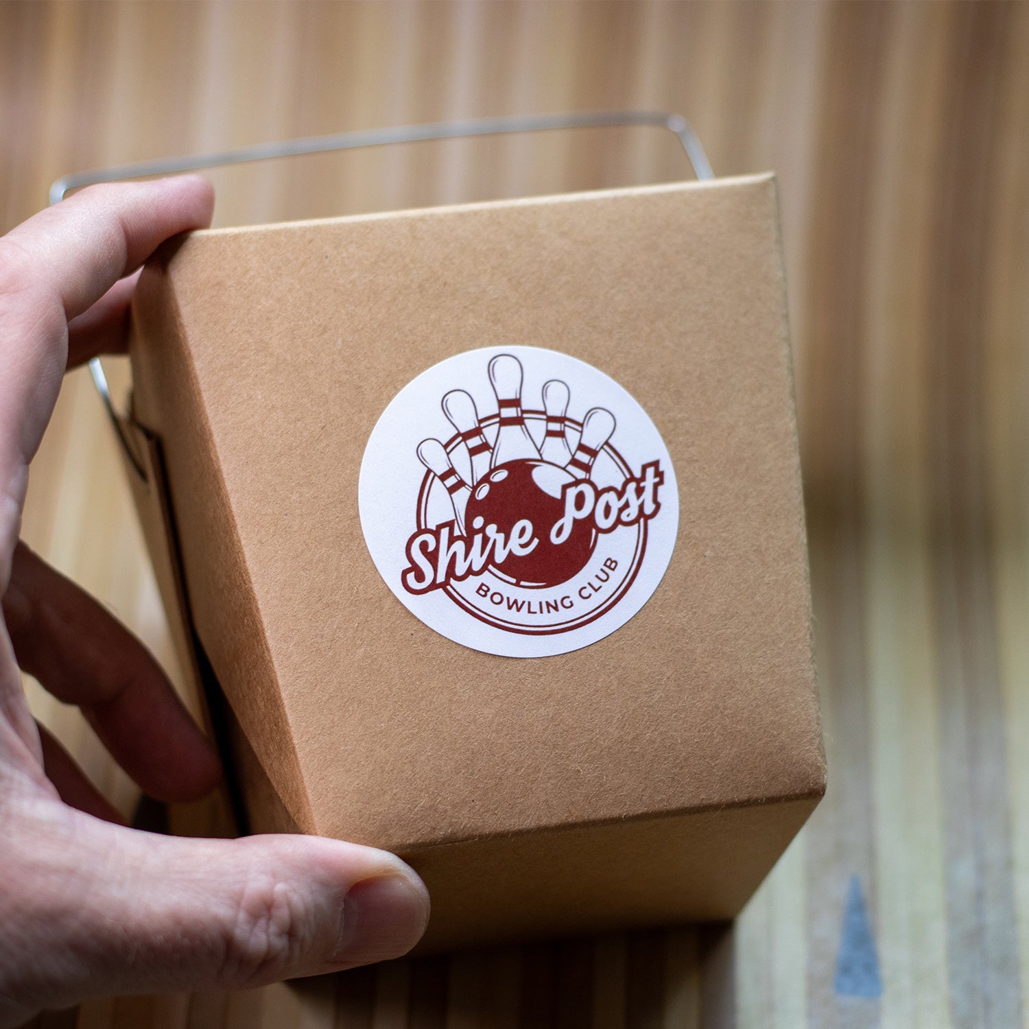 Takeout container displaying "Shire Post Mint Bowling Club" sticker