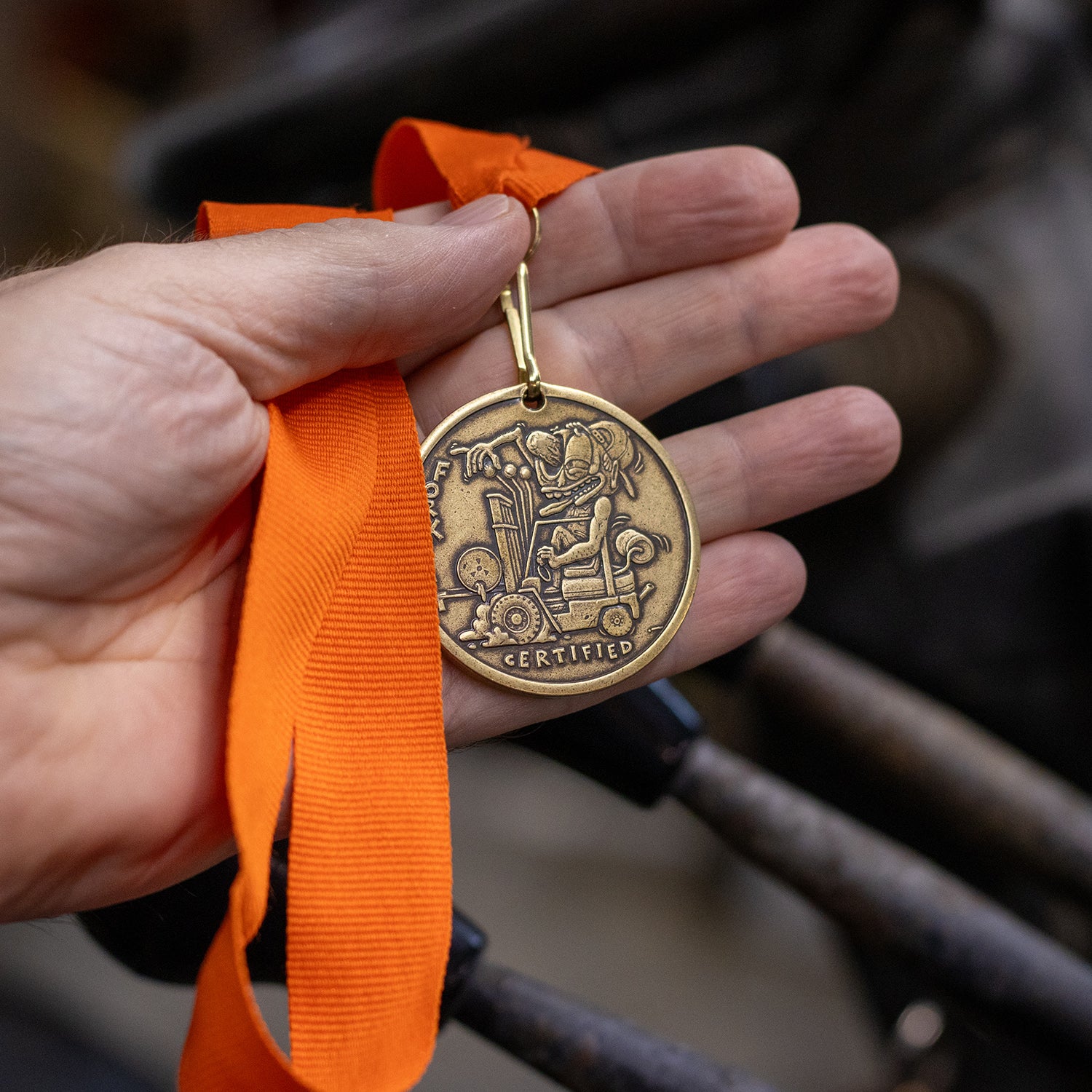 Hand Holding brass Forklift Certified ribbon