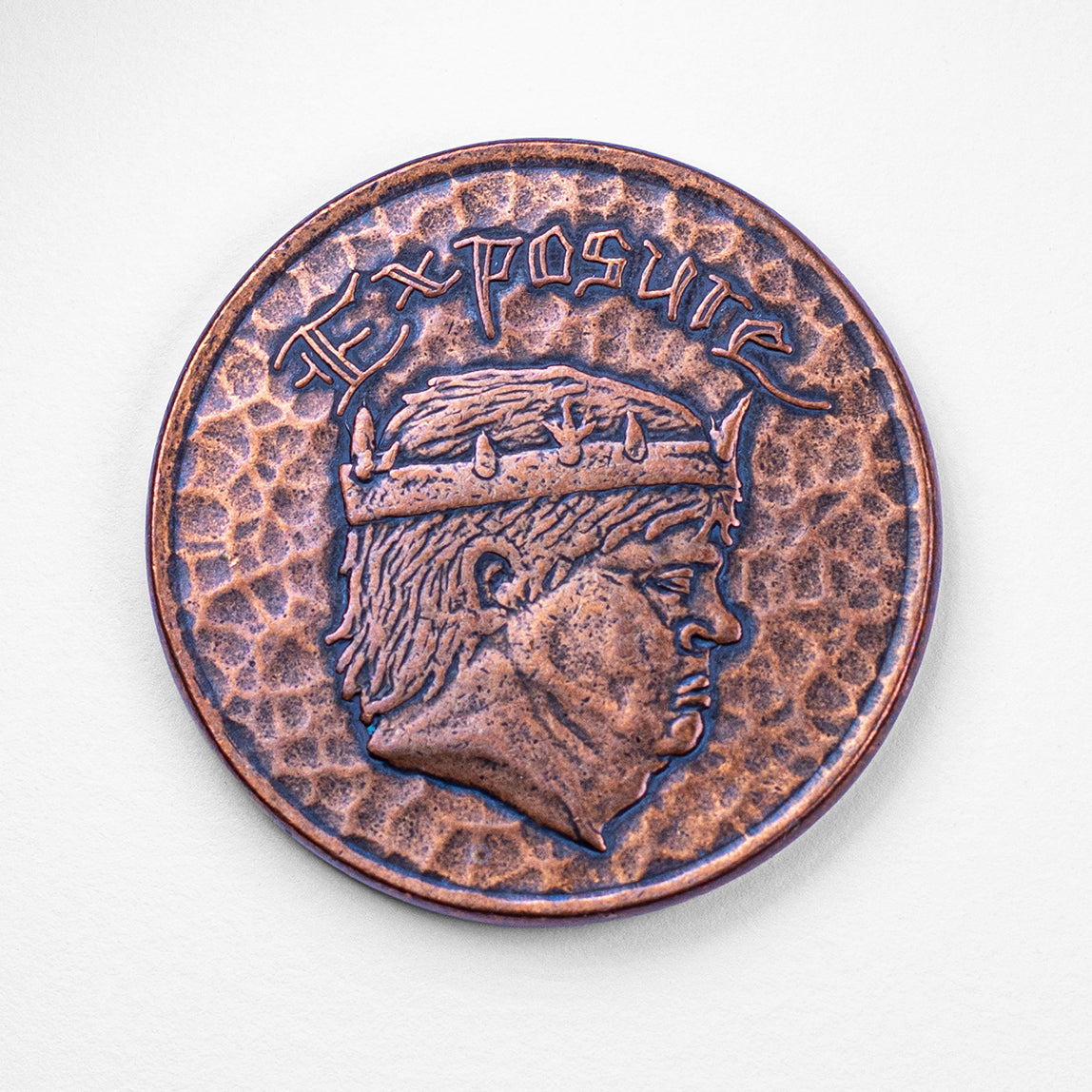Copper Exposure Coin on blank background, showing crowned king side