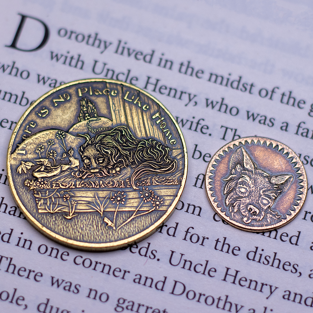 Brass coin with text, 'There Is No Place Like Home' depicting a sleeping dog on a sunny porch displayed on a book page