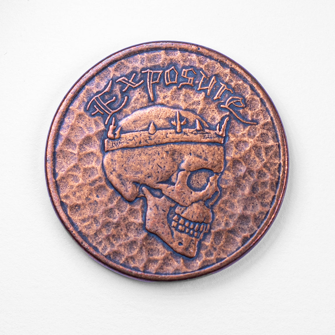 Copper Exposure Coin on white background, crowned skull shown 