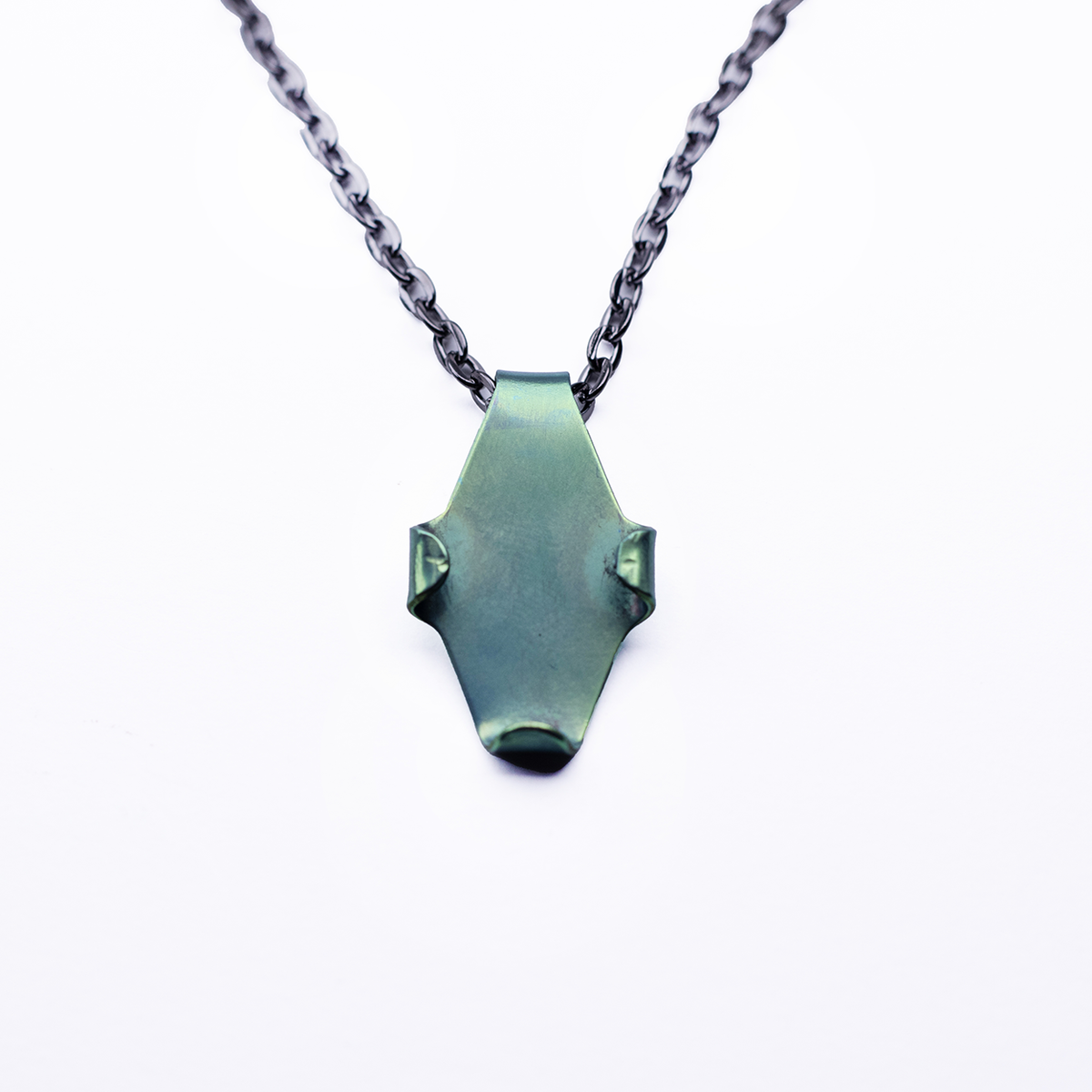 Leaf-shaped niobium green holder pendant against a white background. 