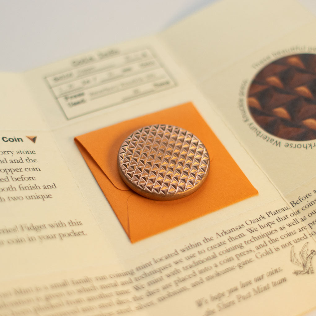 The Duplex coin in raw copper on its coin envelope packaging Duplex Worry Stone - Raw Copper - Hammered and Textured Combo Coin | Shire Post Mint Gifts